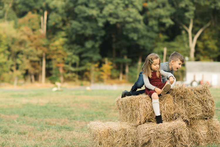 Fall is in full swing here in NJ, my first Fall Family session with Anna and Adam at their Farm House in Hackettstown NJ. Anna and Adam recently purchased their dream farm house on a 4 acres of land. This family of four now has chickens, ducks, birds, cats, a dog, sheep and plans to add many more to the list in the future. I had the honor of visiting Anna and Adam and their two beautiful children at their Farm the other day. I got much need vitamin D walking around the property, enjoying the foliage, running around with their kids and meeting all the farm animals. I sincerely enjoy photographing families now because there are no dull moments with kids, every moment is perfect! Fall family session at Anna and Adam’s Farm at Hackettstown NJ photographed by Karis from HeyKaris.